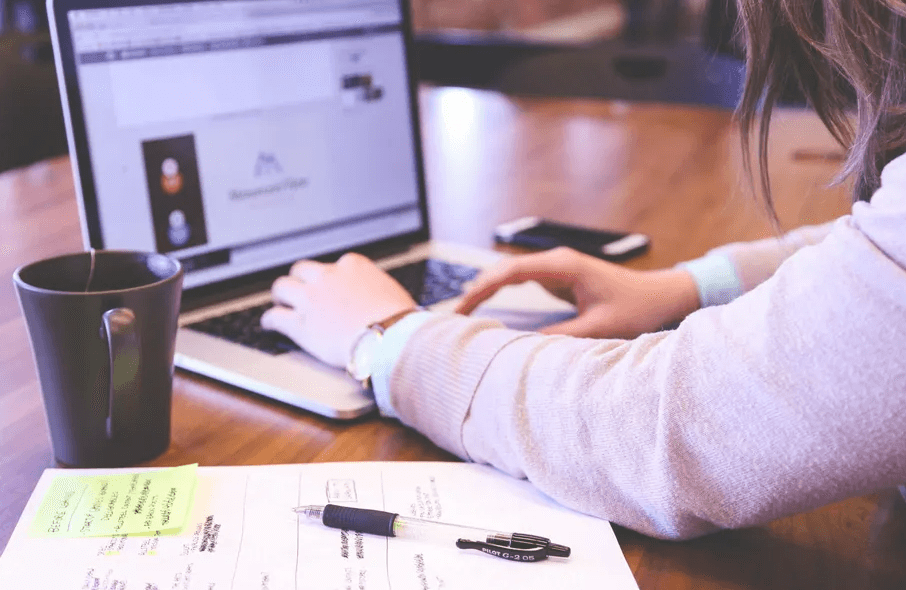 woman typing on laptop